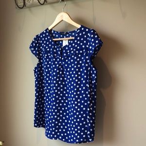 Blue cap sleeved blouse with white polka dots.
